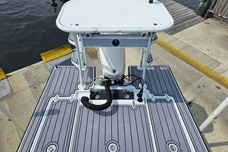 Slide: The Image of 2012 East Cape Fury boat deck with motor, docked by the water. - 16