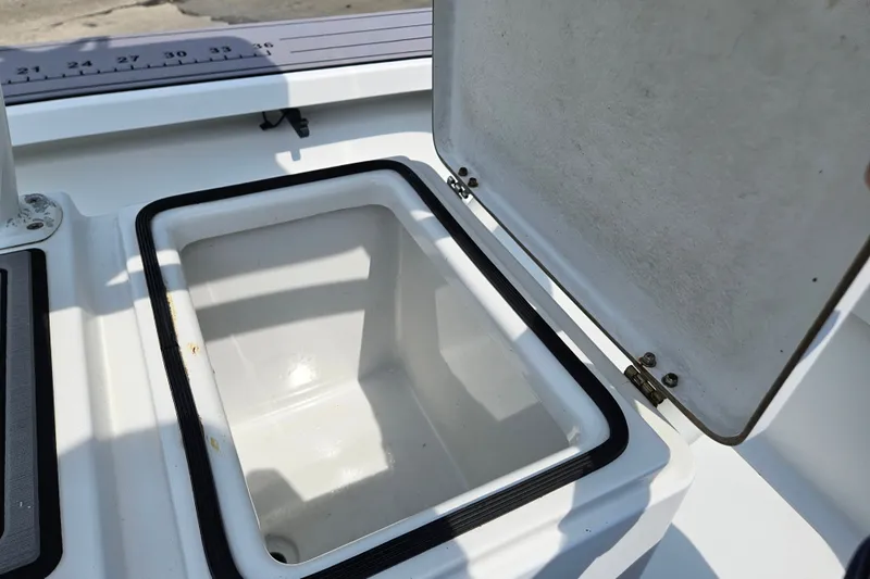 Slide: The Image of Open storage compartment on a 2012 East Cape Fury boat, featuring a measuring scale. - 20