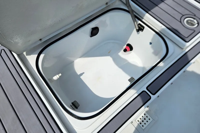 Slide: The Image of Open storage compartment on a 2012 East Cape Fury boat, featuring clean interior and deck details. - 18