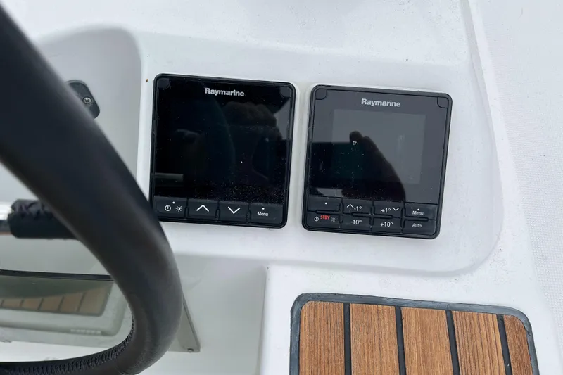 Slide: The Image of Two Raymarine displays are mounted on the helm console of a 2019 Jeanneau Sun Odyssey 349. - 12