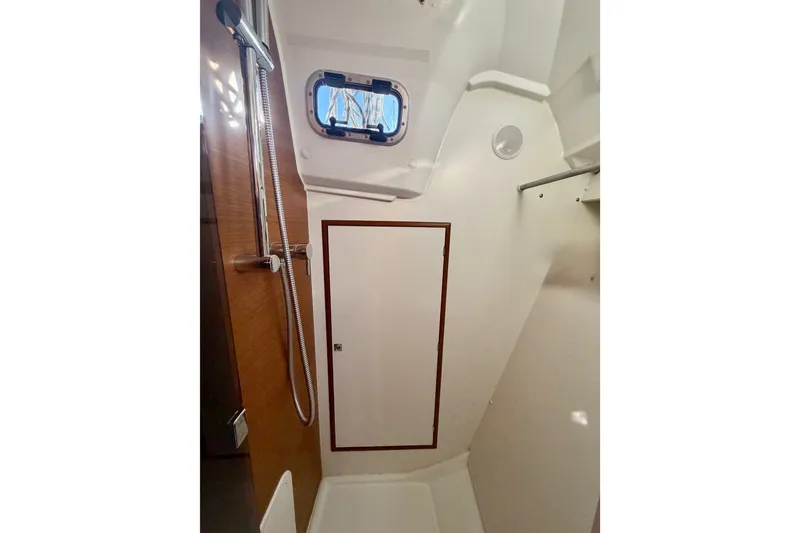 Slide: The Image of Interior of 2019 Jeanneau Sun Odyssey 349 sailboat bathroom with shower and window. - 35