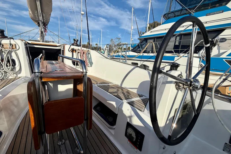 Slide: The Image of Cockpit view of 2019 Jeanneau Sun Odyssey 349 sailboat with steering wheel and seating. - 13