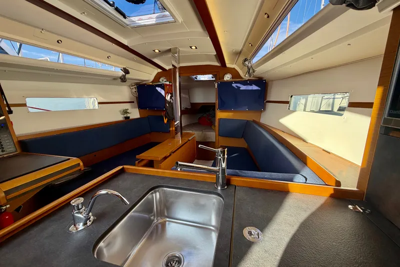 Slide: The Image of Interior of 2019 Jeanneau Sun Odyssey 349 sailboat with modern kitchen and seating area. - 28