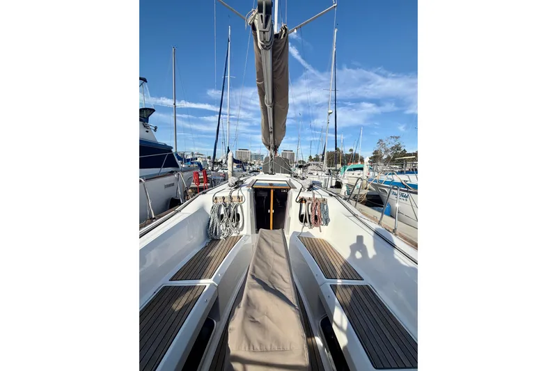 Slide: The Image of 2019 Jeanneau Sun Odyssey 349 sailboat docked at marina, clear blue sky. - 4