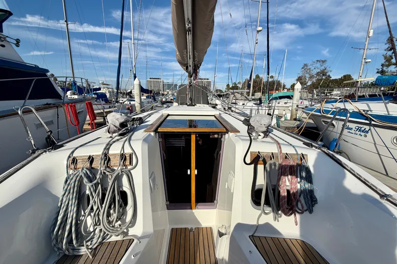 Slide: The Image of 2019 Jeanneau Sun Odyssey 349 sailboat docked at marina, showcasing deck and rigging. - 5
