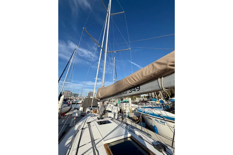 Slide: The Image of 2019 Jeanneau Sun Odyssey 349 sailboat docked under clear blue sky. - 14