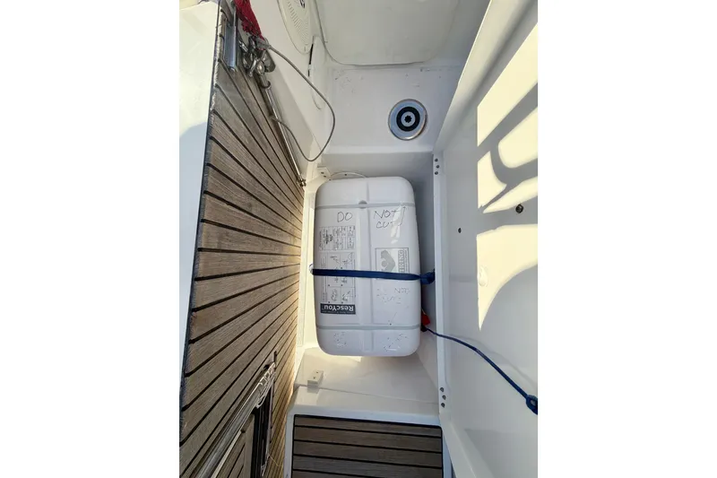 Slide: The Image of 2019 Jeanneau Sun Odyssey 349 deck with secured liferaft and wooden flooring. - 39