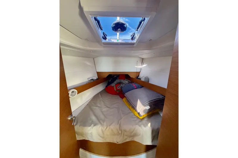 Slide: The Image of Cozy cabin interior of 2019 Jeanneau Sun Odyssey 349 sailboat with bedding and skylight. - 33