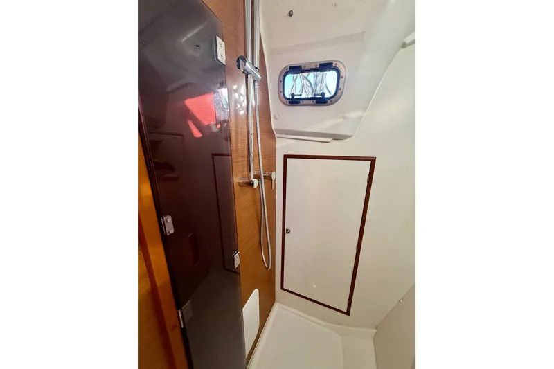 Slide: The Image of Interior of 2019 Jeanneau Sun Odyssey 349 yacht bathroom with shower and window. - 36