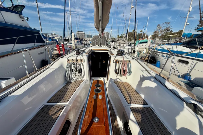 Slide: The Image of 2019 Jeanneau Sun Odyssey 349 sailboat docked at marina, showcasing deck and rigging. - 6