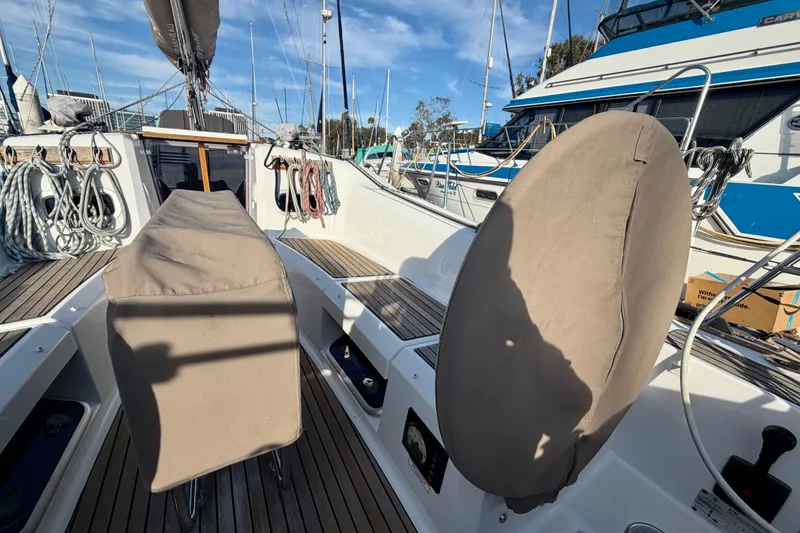 Slide: The Image of 2019 Jeanneau Sun Odyssey 349 sailboat cockpit with covered equipment and ropes. - 9