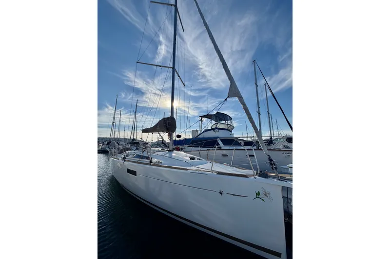 Slide: The Image of 2019 Jeanneau Sun Odyssey 349 sailboat docked at marina under blue sky. - 3