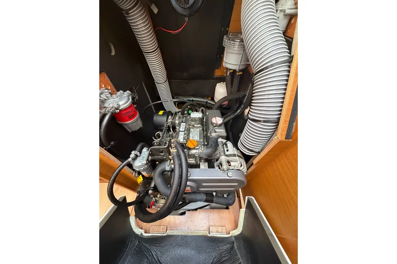 Slide: The Image of Engine compartment of 2019 Jeanneau Sun Odyssey 349 sailboat, showcasing mechanical components. - 38