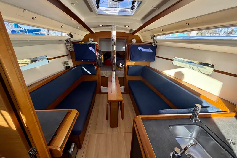 Slide: The Image of Interior of 2019 Jeanneau Sun Odyssey 349 sailboat, featuring cozy seating and modern amenities. - 25