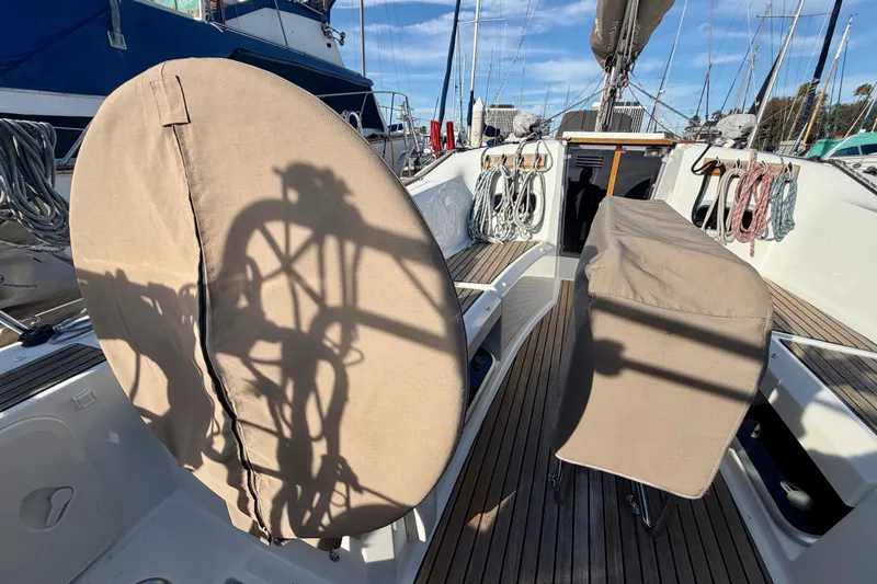 Slide: The Image of 2019 Jeanneau Sun Odyssey 349 sailboat cockpit with covered wheel and ropes. - 8