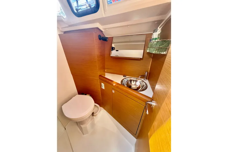 Slide: The Image of 2019 Jeanneau Sun Odyssey 349 bathroom with wooden cabinetry and stainless steel sink. - 34