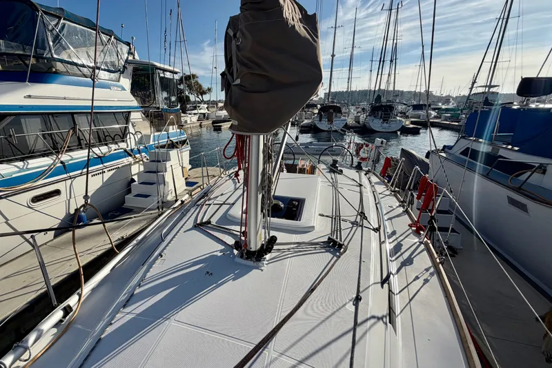 Slide: The Image of 2019 Jeanneau Sun Odyssey 349 sailboat docked at a marina, surrounded by other boats. - 17