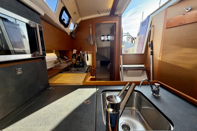 Slide: The Image of Interior of 2019 Jeanneau Sun Odyssey 349 yacht kitchen with sink and stove. - 30