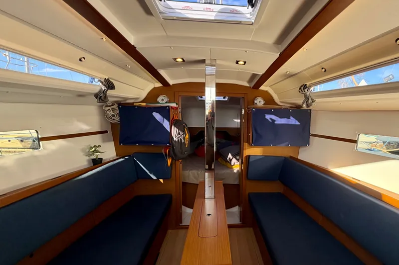 Slide: The Image of Interior of 2019 Jeanneau Sun Odyssey 349 sailboat, featuring cozy seating and natural light. - 20