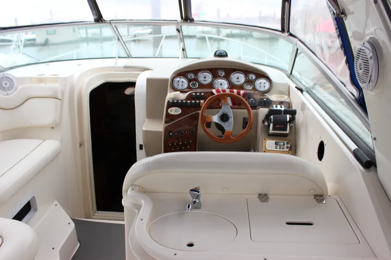 Slide: The Image of 2006 Rinker 290 Express Cruiser cockpit with steering wheel and control panel. - 14