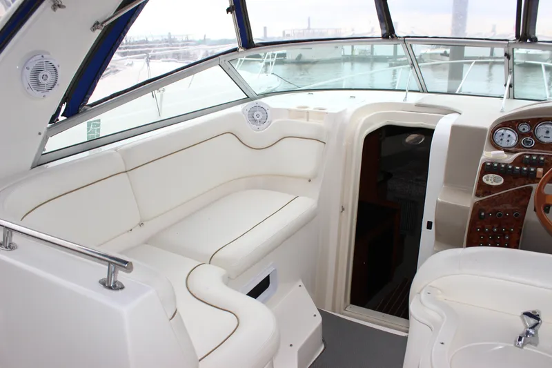Slide: The Image of 2006 Rinker 290 Express Cruiser interior with seating and control panel. - 15