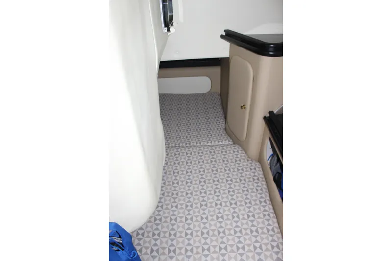 Slide: The Image of Interior cabin of 2006 Rinker 290 Express Cruiser with patterned flooring. - 25