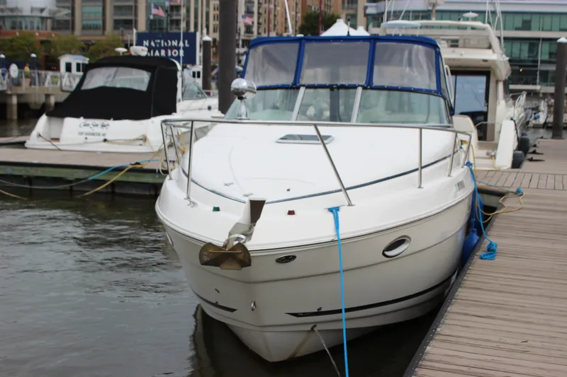 Slide: The Image of 2006 Rinker 290 Express Cruiser docked at marina, front view. - 1