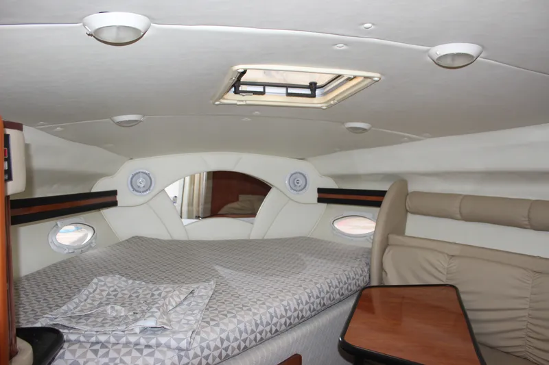 Slide: The Image of Interior cabin of 2006 Rinker 290 Express Cruiser with bed and seating area. - 22