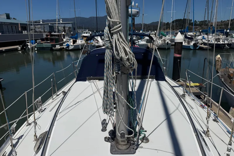Slide: The Image of 1996 Catalina 36 MkII sailboat docked in a marina, surrounded by other boats. - 19