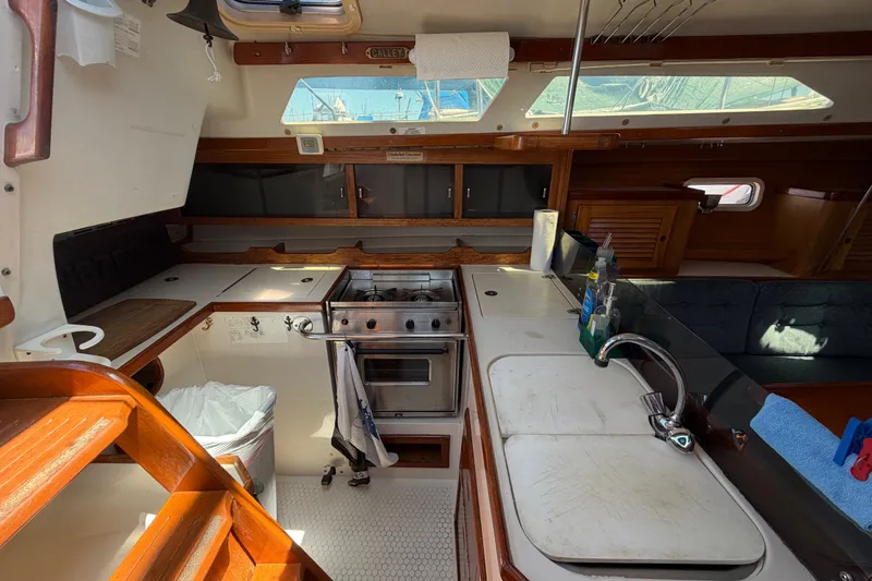 Slide: The Image of Interior of a 1996 Catalina 36 MkII sailboat, featuring a compact kitchen galley. - 37