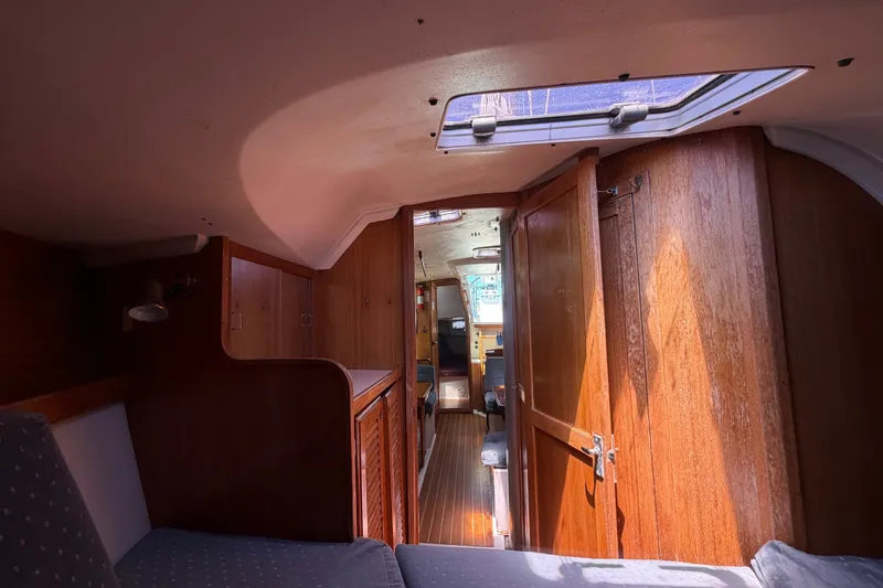 Slide: The Image of Interior of a 1996 Catalina 36 MkII sailboat, featuring wooden cabinetry and seating. - 45