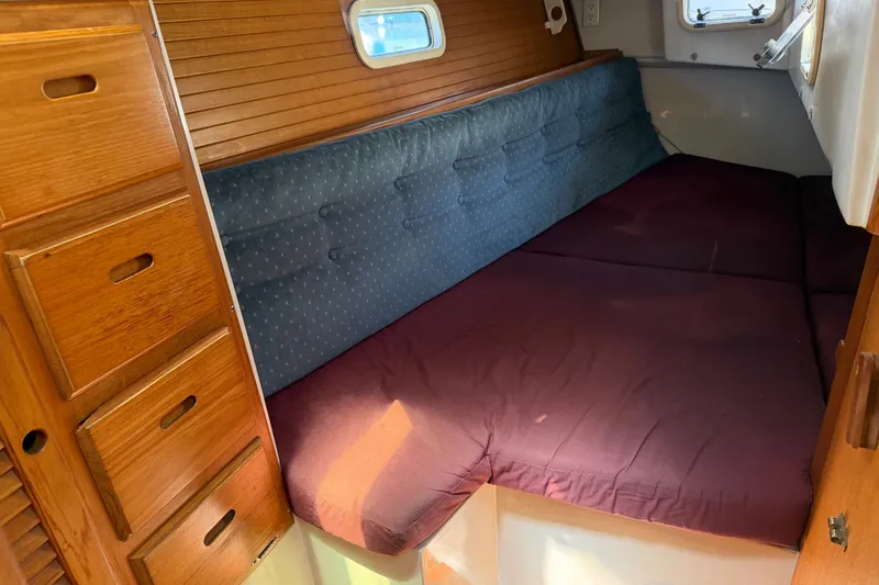 Slide: The Image of Cozy cabin interior of 1996 Catalina 36 MkII sailboat with wooden drawers and cushioned seating. - 48