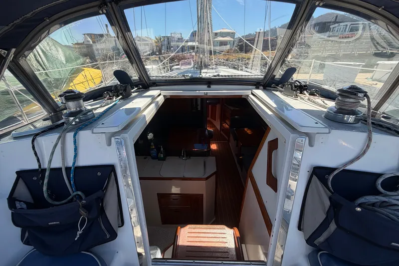 Slide: The Image of Interior view of a 1996 Catalina 36 MkII sailboat, showcasing the cockpit and cabin entrance. - 34