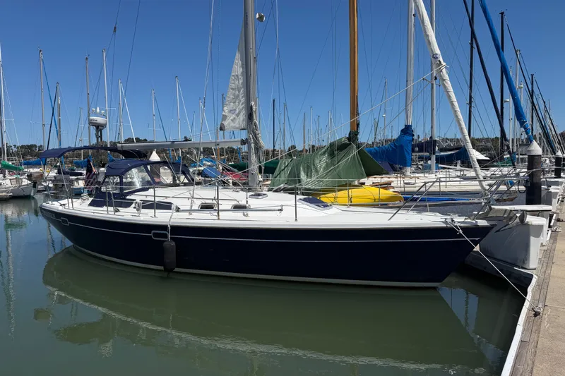 Slide: The Image of 1996 Catalina 36 MkII sailboat docked in a marina under clear blue skies. - 24