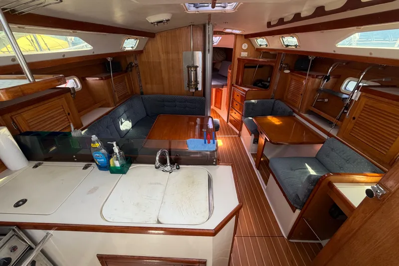 Slide: The Image of Interior of a 1996 Catalina 36 MkII sailboat with cozy seating and wooden finishes. - 39