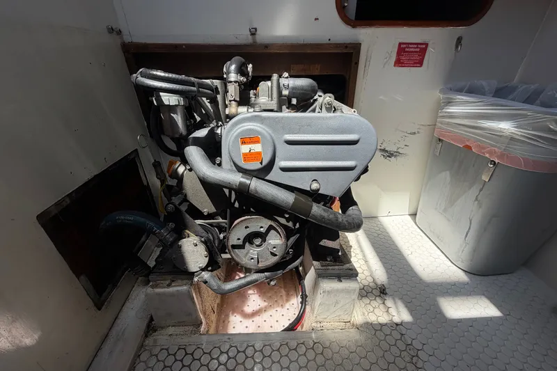 Slide: The Image of Engine compartment of a 1996 Catalina 36 MkII sailboat, showcasing mechanical components. - 51