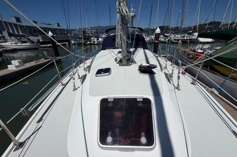 Slide: The Image of 1996 Catalina 36 MkII sailboat docked at a marina, showcasing deck and rigging. - 18