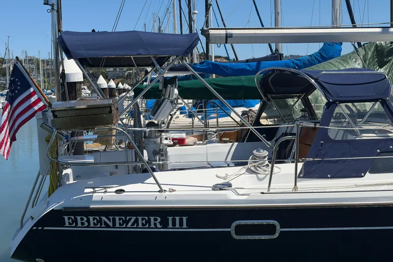Slide: The Image of Sailboat "Ebenezer III," a 1996 Catalina 36 MkII, docked with American flag. - 22