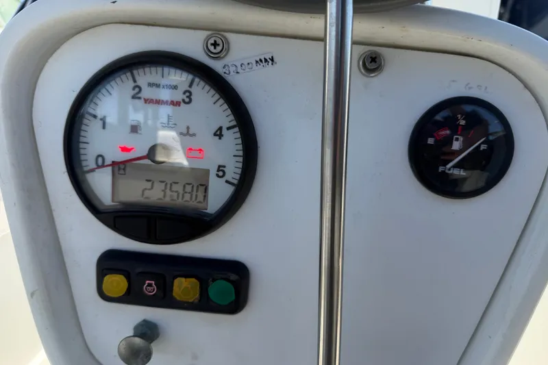 Slide: The Image of Close-up of Catalina 36 MkII 1996 engine gauges, showing RPM and fuel levels. - 31
