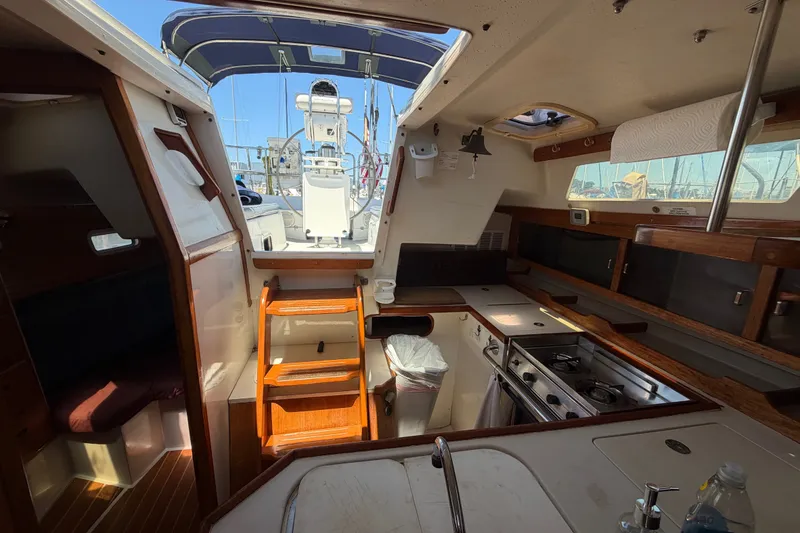 Slide: The Image of Interior of a 1996 Catalina 36 MkII sailboat with kitchen and seating area. - 36