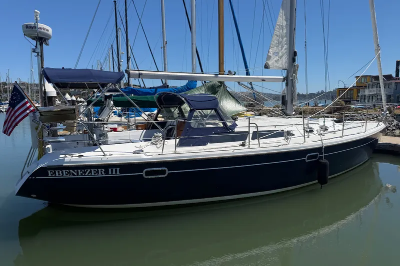 Slide: The Image of 1996 Catalina 36 MkII sailboat "Ebenezer III" docked in a marina, featuring a navy hull. - 23