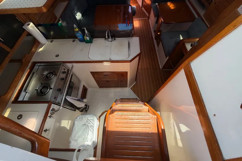 Slide: The Image of Interior of 1996 Catalina 36 MkII sailboat, featuring a compact kitchen and dining area. - 35