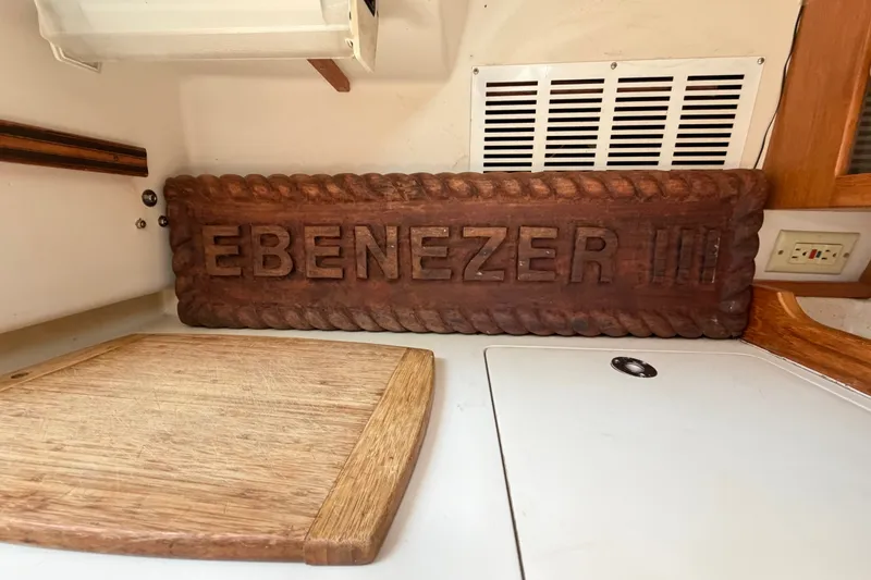 Slide: The Image of Wooden "EBENEZER III" sign inside a 1996 Catalina 36 MkII boat cabin. - 38