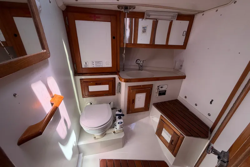 Slide: The Image of 1996 Catalina 36 MkII yacht bathroom with wooden accents and compact design. - 43