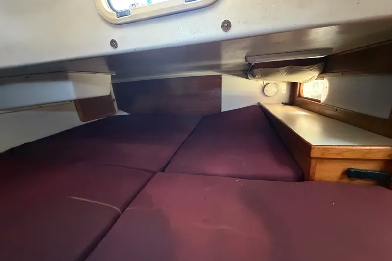Slide: The Image of Interior cabin of a 1996 Catalina 36 MkII sailboat with maroon cushions. - 49