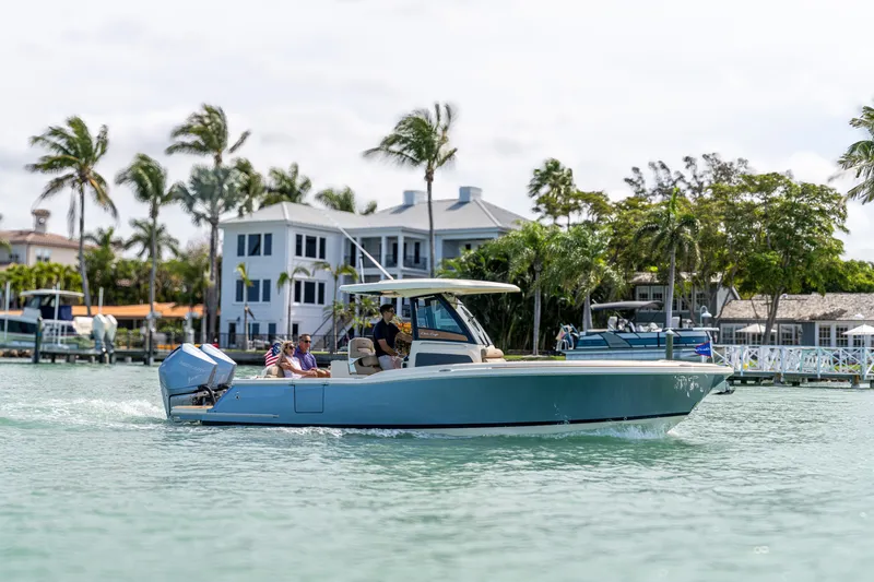 Slide: The Image of 2026 Chris-Craft Catalina 28 cruising on a sunny waterfront with palm trees. - 0