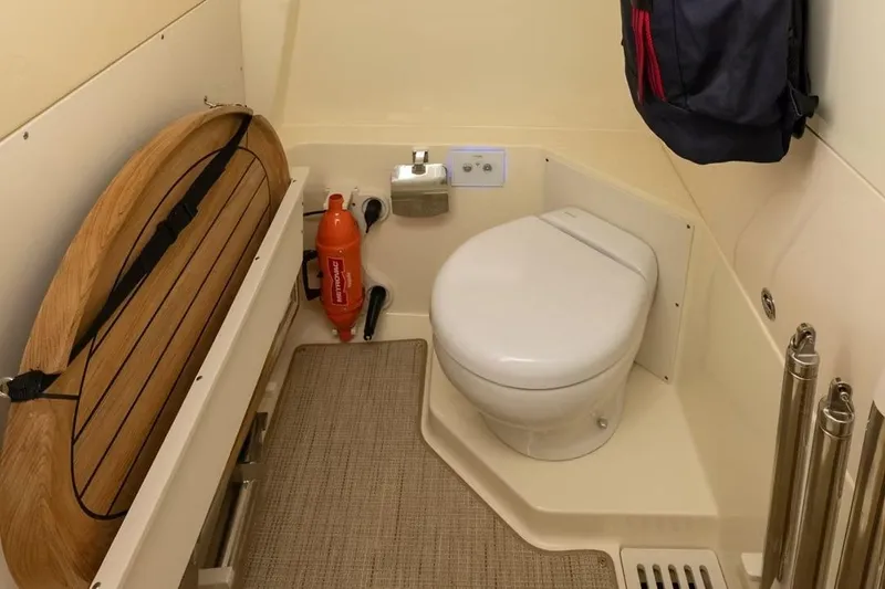 Slide: The Image of Manufacturer Provided Image: Bathroom interior of 2026 Chris-Craft Catalina 28 boat, featuring a compact toilet and safety equipment. - 5