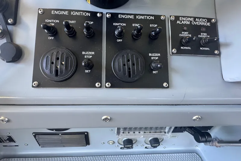 Slide: The Image of Control panel of a 2004 Zodiac Milpro Hurricane boat with engine ignition switches. - 20