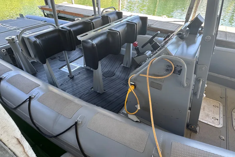Slide: The Image of 2004 Zodiac Milpro Hurricane boat interior with seating and control panel. - 11
