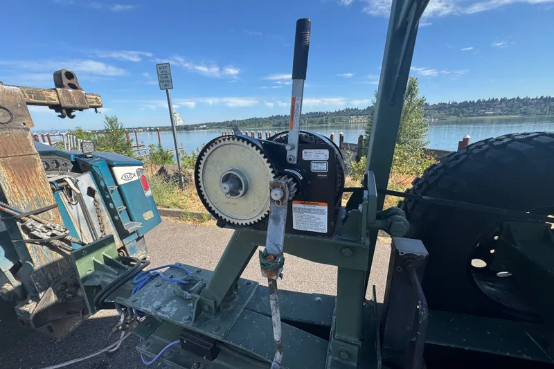 Slide: The Image of Boat trailer winch mechanism near a scenic waterfront, Zodiac Milpro Hurricane 2004 model. - 52